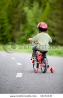 stock-photo--years-old-boy-wearing-safety-bicycle-helmet-riding-a-bike-14131117.jpg